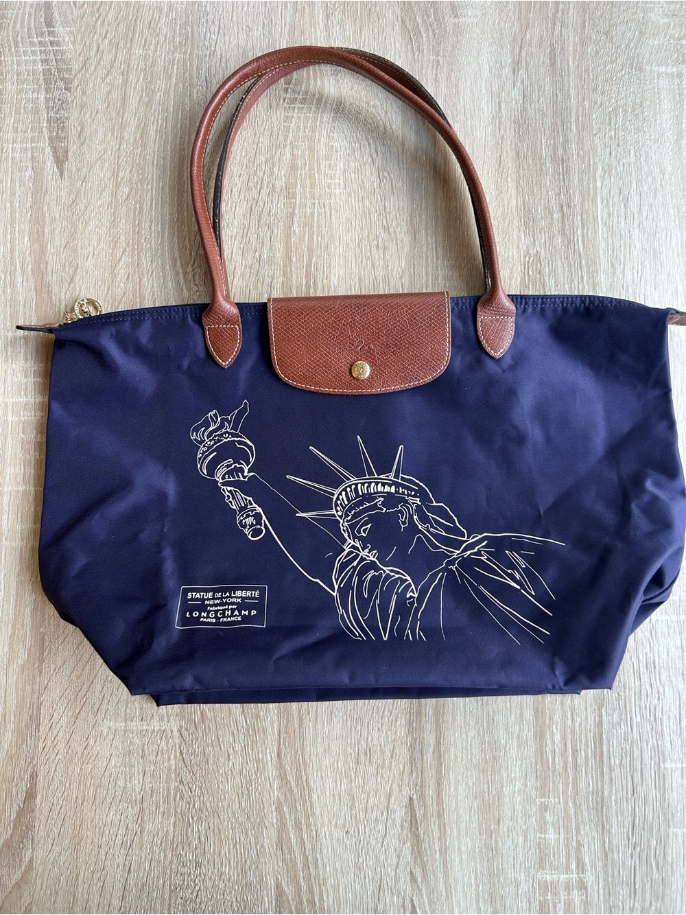 Longchamp Navy Tote with Brown Leather Trim and Statue of Liberty Graphic
